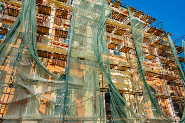 istock Building structure with netting shade and scaffolding covered 1402266799