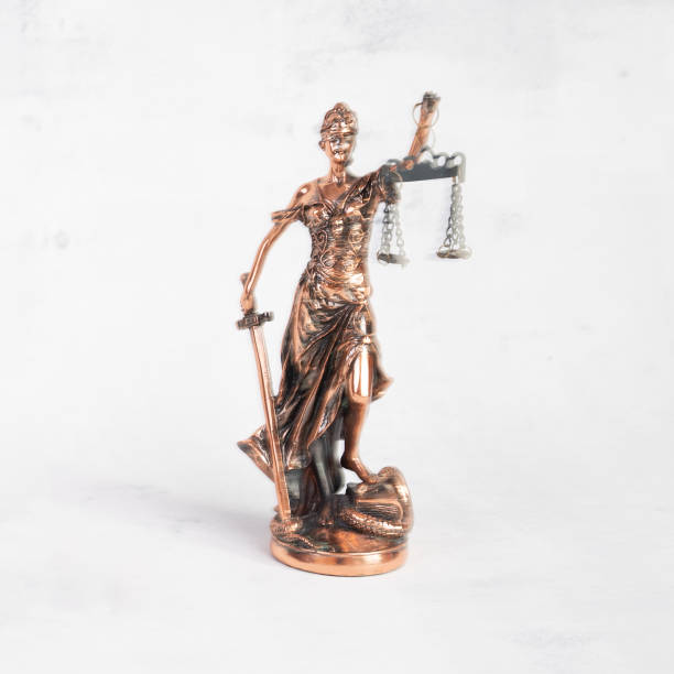 istock Blur Justilia or Themis (Symbol of Justice) statue isolated on white background with clipping path 1402267136
