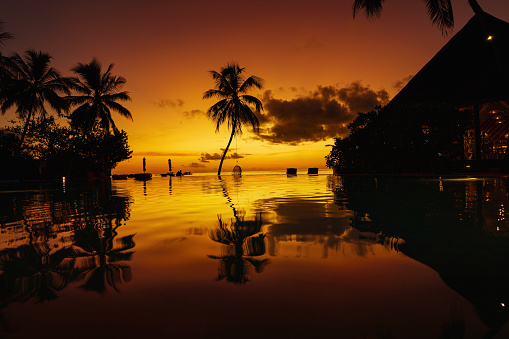 Maldives, Sun Aqua Vilu Reef. 15.04.22. Amazing island sunset beach view, palms swimming pool.