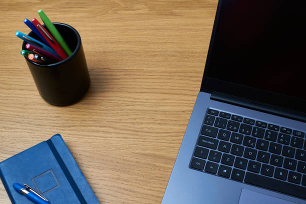 istock Notebook with color pencils and laptop 1402268418