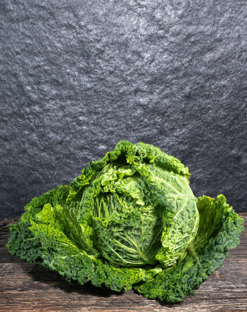 istock Raw, fresh savoy cabbage on wooden background 1402268939
