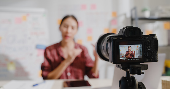 Close up of young Asian woman teacher teaching online lesson class on video call via camera at home.