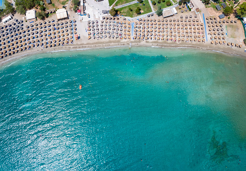 Aerial top view of the beautiful beach at Vouliagmeni, south Athens Riviera coast, Greece, with turquoise sea