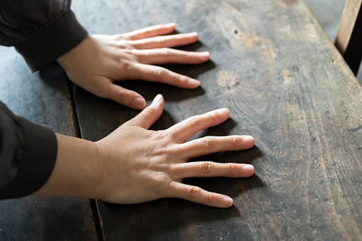 Hand placed on the desk