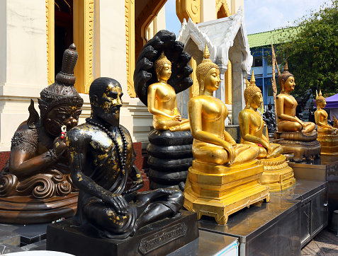 Statues of deities in front of a temple in Bangkok, Thailand