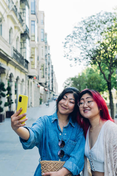 istock Cheerful Japanese women taking selfie on weekend day 1402273350