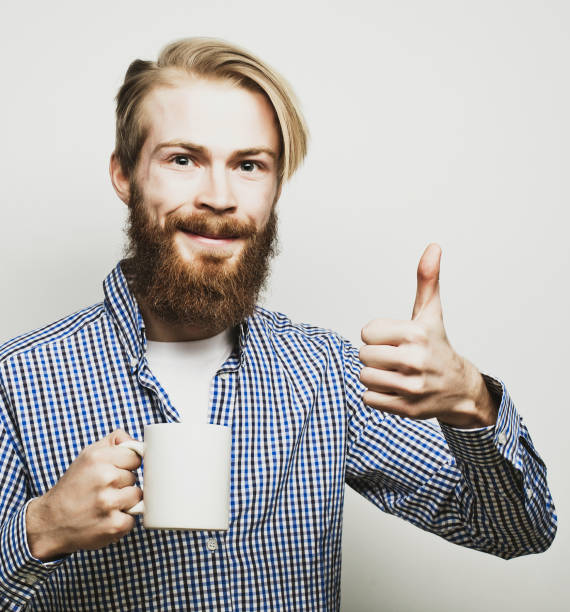 istock man with a cup of coffee 1402274696