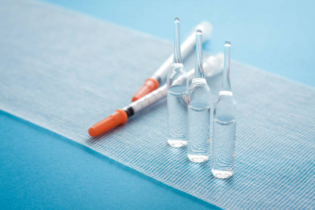 ampules and syringes on steile bandage surface. close up image of medical supplies. - syringe vaccination vial insulin imagens e fotografias de stock