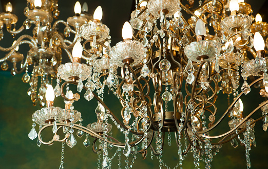 Beautiful vintage crystal chandelier in a room, Golden tones.