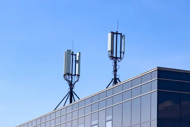 Photo of 4G 5G GSM cellular transmitter and signal repeater antenna on a roof