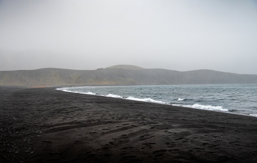 Kleifarvatn lake in Iceland near Reykjavik during a misty day with low rising fog. Icelandic travel scenery abstract