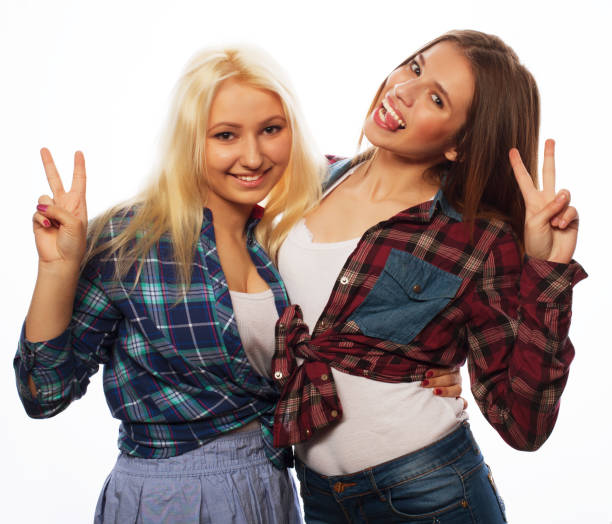 istock two young girl friends standing together and having fun 1402277538