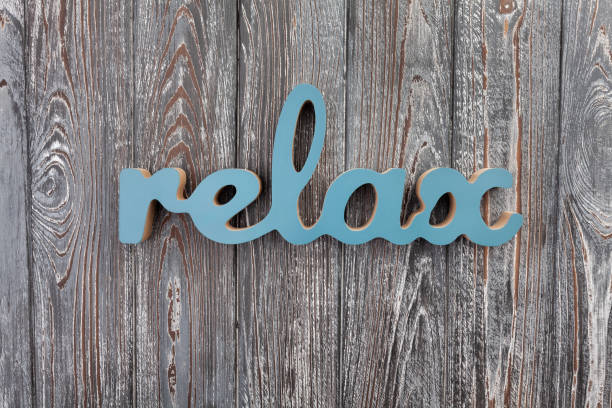 carved wooden letters relax on wood background