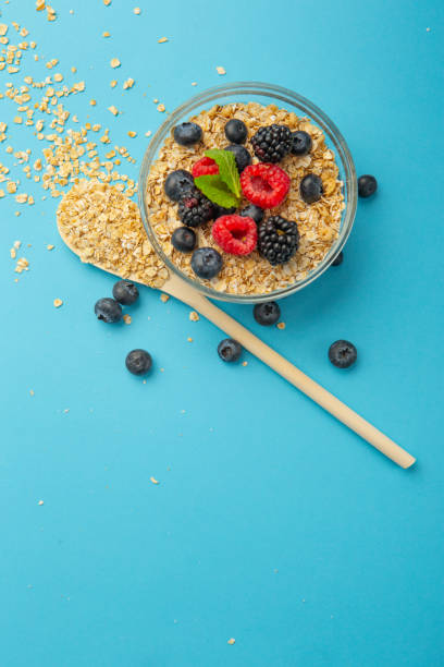 Small bowl of dry oatmeal with fruits stock photo