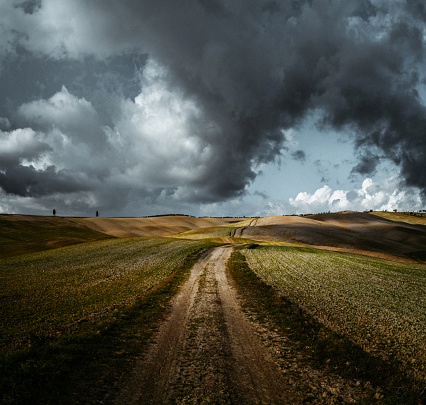 Beautiful view at Val d'Orcia against moody clouds. Italy, Tuscany
