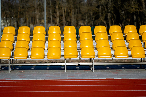 Grandstand stadium with yellow seats outdoors front view