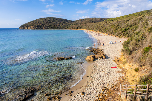 People relaxing at the Cala Violina, a cove in the Maremma within the Bandite di Scarlino nature reserve