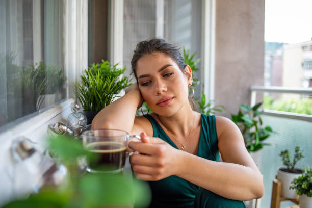 istock Young woman having coffee on the terrace 1402291328