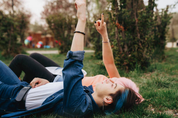 istock Two young lgbt women are lying down on grass in a park 1402291549
