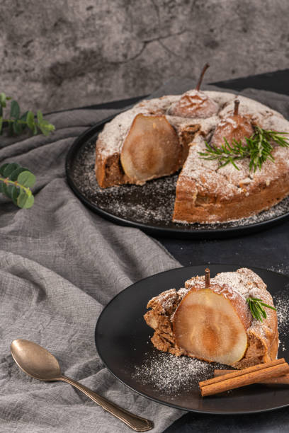 istock Delicious spice cake with pear, ginger and cinnamon on a dark kitchen counter. 1402292096