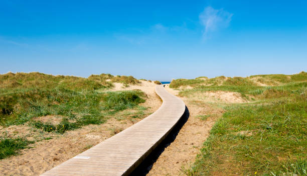 A wooden boardwalk leading to Solastranden beach from the car park and hotel resort stock photo