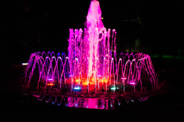 istock A glowing multicolored musical water fountain at night. 1402298743