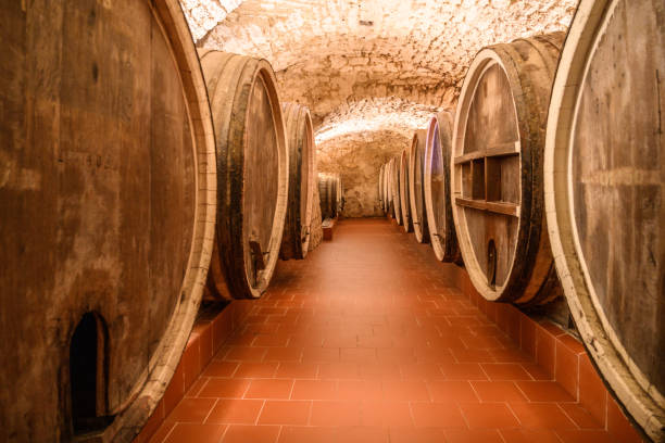 istock Vintage winery cellar with wine wooden barrels 1402299888