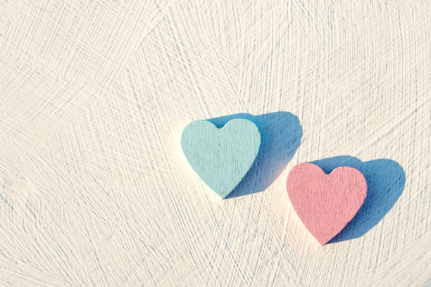 istock red and blue heart made of wood on a white textured surface 1402302899