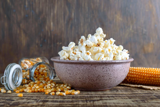 istock A large bowl of popcorn, corn grains and corncob on a wooden table. Close-up. 1402303012