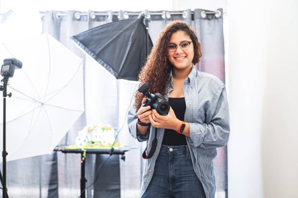 istock A young Latin American photographer holding a professional camera. 1402304424
