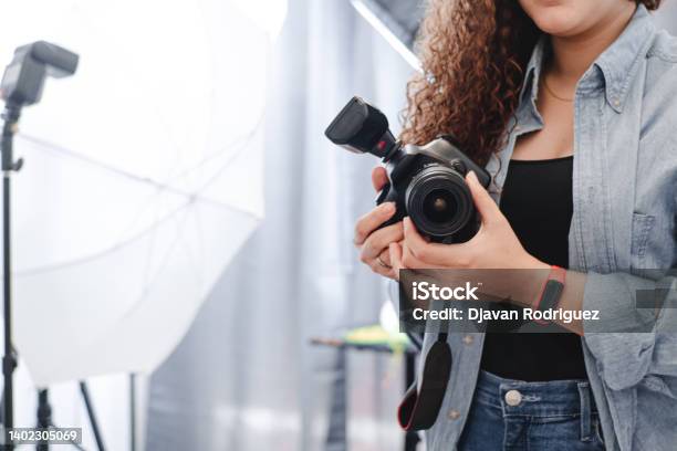 Unknown Photographer Woman Holding A Professional Camera On The Studio Stock Photo - Download Image Now
