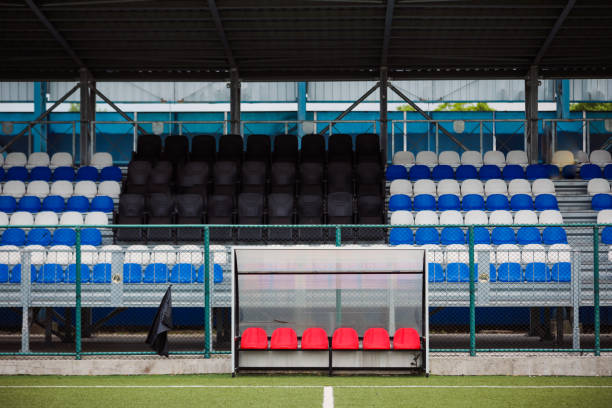 empty soccer field, bench with red seats - soccer soccer field artificial turf man made material imagens e fotografias de stock