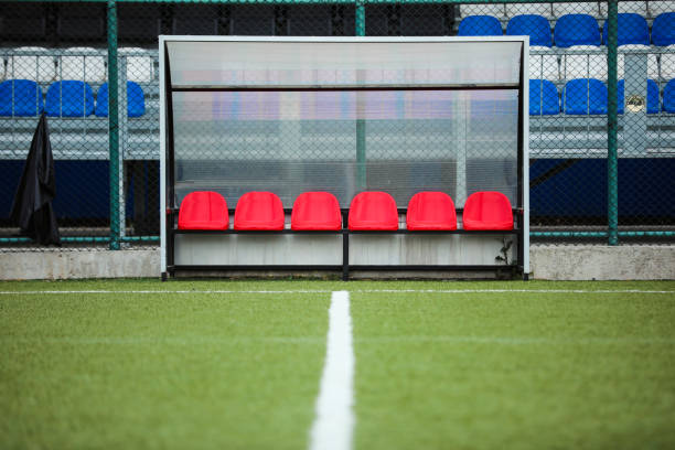 istock Empty Soccer Field, Bench With Red Seats 1402305197