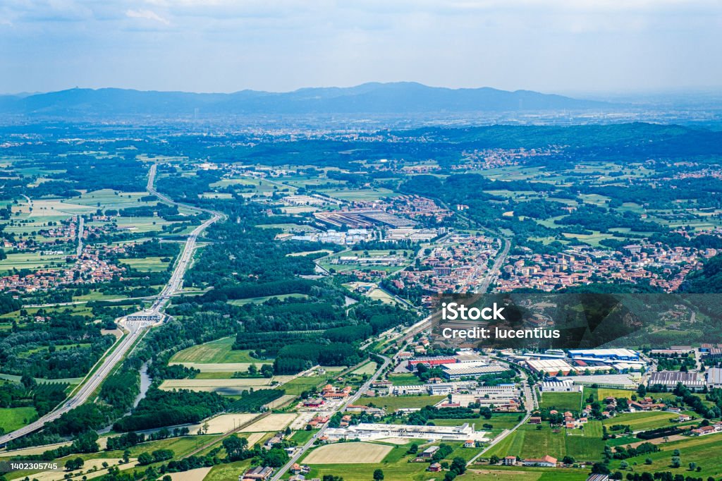 Susa valley, Piedmont, Italy Looking east along the Susa Valley towards the distant city of Turin, Italy. The prominent road is the E70 toll autoroute. Color Image Stock Photo