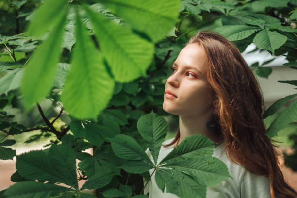 istock Young girl in on natural green background 1402308146