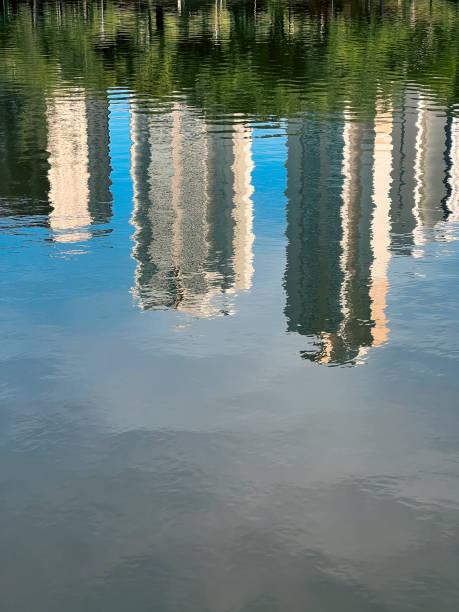 istock Buildings reflected in a lake on a summer day. 1402309720