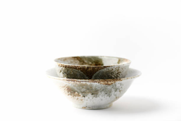 istock Traditional ceramic bowls on bright paper background. Soft focus. Close up. Copy space. 1402311794