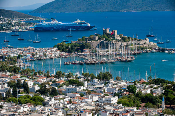 Muğla - Bodrum, Turkey - September 7, 2017 : Bodrum is one of the places where local and foreign tourists come heavily during the summer months. Especially Bodrum Castle is the most popular place.\n\nBodrum marina and the Maltese flagged cruise ship 'Mein Schiff 2', which brings passengers to Bodrum, can be seen in the background.
