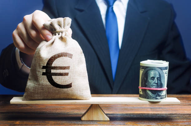 istock Man puts a euro money bag on scales opposite to dollar bundle. Exchange rate, comparison economic indicators. Avoiding savings inflation. Monetary policy. Central Bank Regulator. Market fluctuations 1402318177