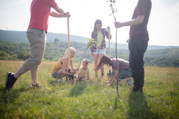istock A group of friends plant a tree in nature. 1402320024