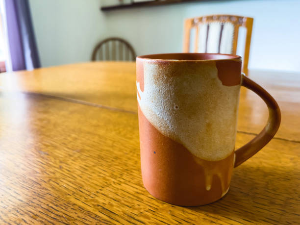 istock Single Coffee Cup on Dining Table - Common Things In and Around the Home Domestic Home Elements Photo Series 1402322428