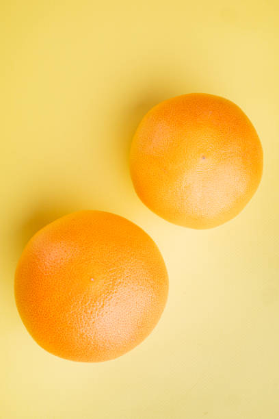 istock Fresh grapefruits, on yellow textured summer background, top view flat lay, with copy space for text 1402322503