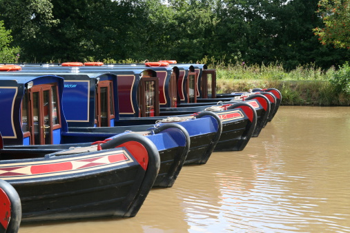 A row of brightly painted canal boats