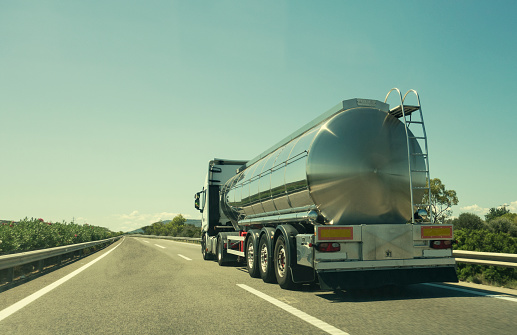 Silver tanker truck for transportation of liquids and flammable material on the highway