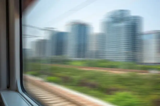 blurred abstract green landscape seen from a window train in motion
