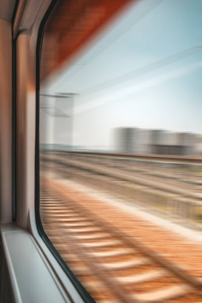 blurred abstract green landscape seen from a window train in motion stock photo