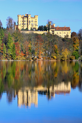 Germany, Neuschwanstein Castle. View of the castle and the Bavarian Alps at sunrise during fall season.