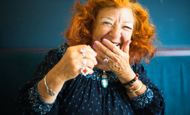 The hearty laugh of the elegant old lady. Portrait of an old lady. She laughs heartily to the viewer. She has a friendly and candid character. And a lot of fun! only senior women stock pictures, royalty-free photos & images