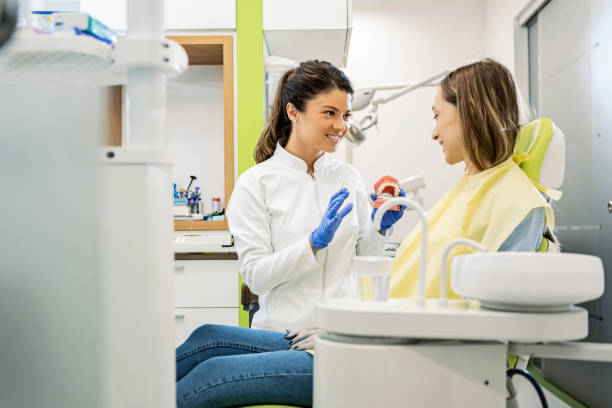 istock Young female dentist with patient 1402328208
