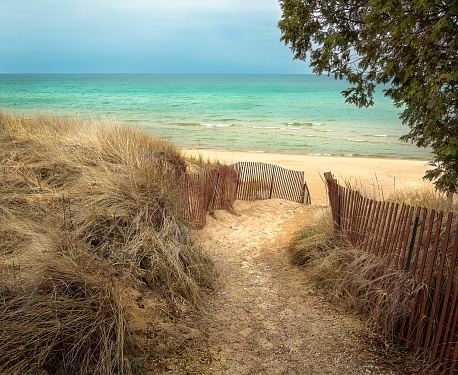 Path on a sand dune leading to open water of Lake Michigan at Whitefish Dunes State Park